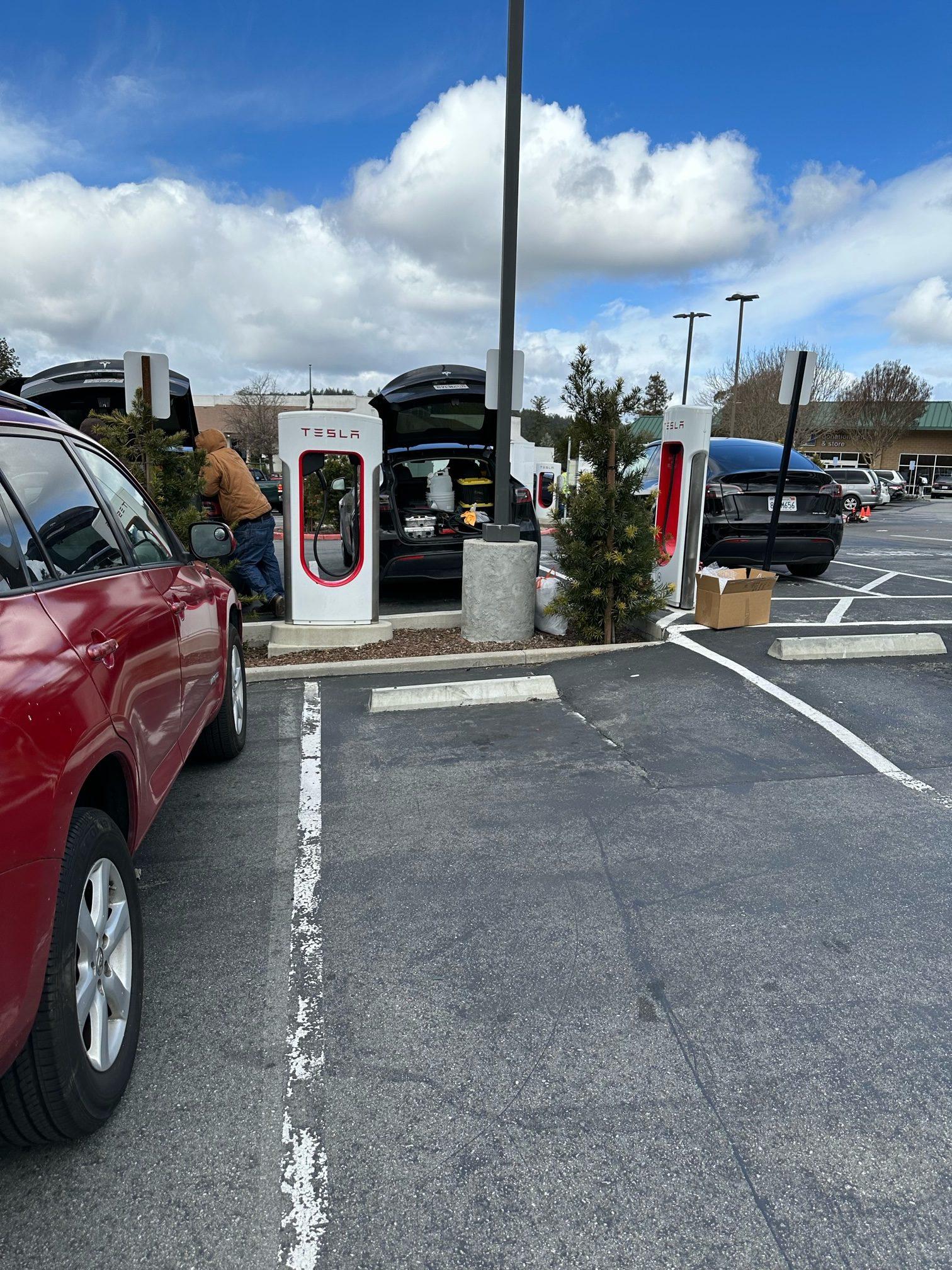 Cybercab Robotaxi First Supercharger with Magic Dock CCS Adapter charges up a Rivian tesla 3