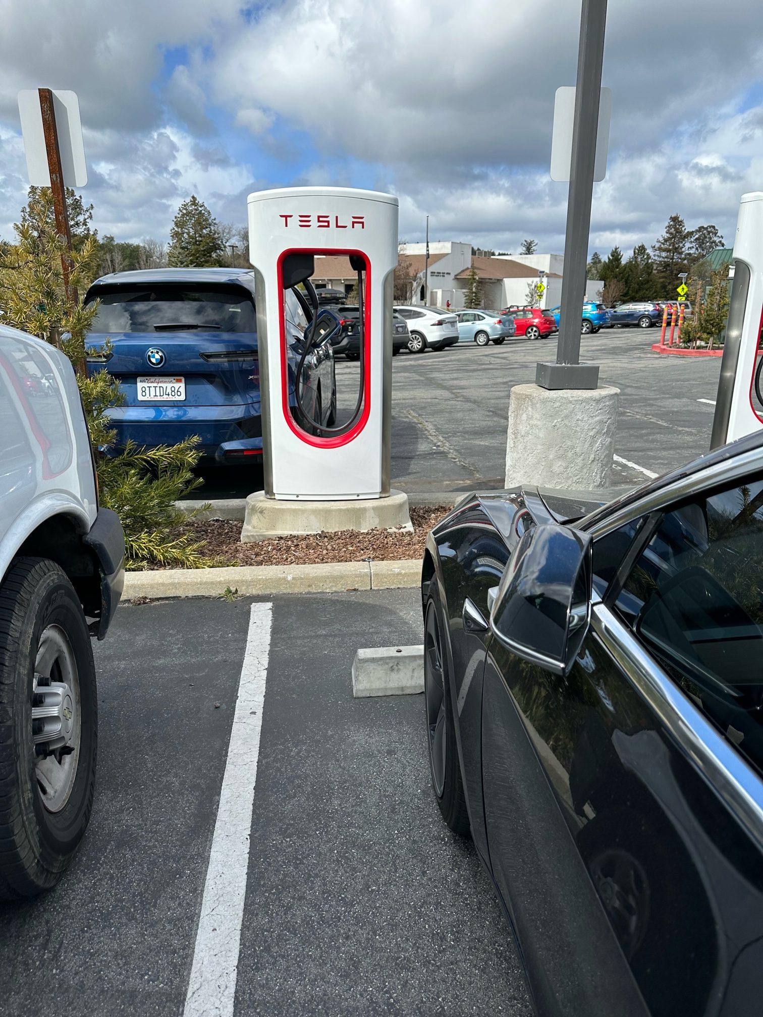 Cybercab Robotaxi First Supercharger with Magic Dock CCS Adapter charges up a Rivian tesla